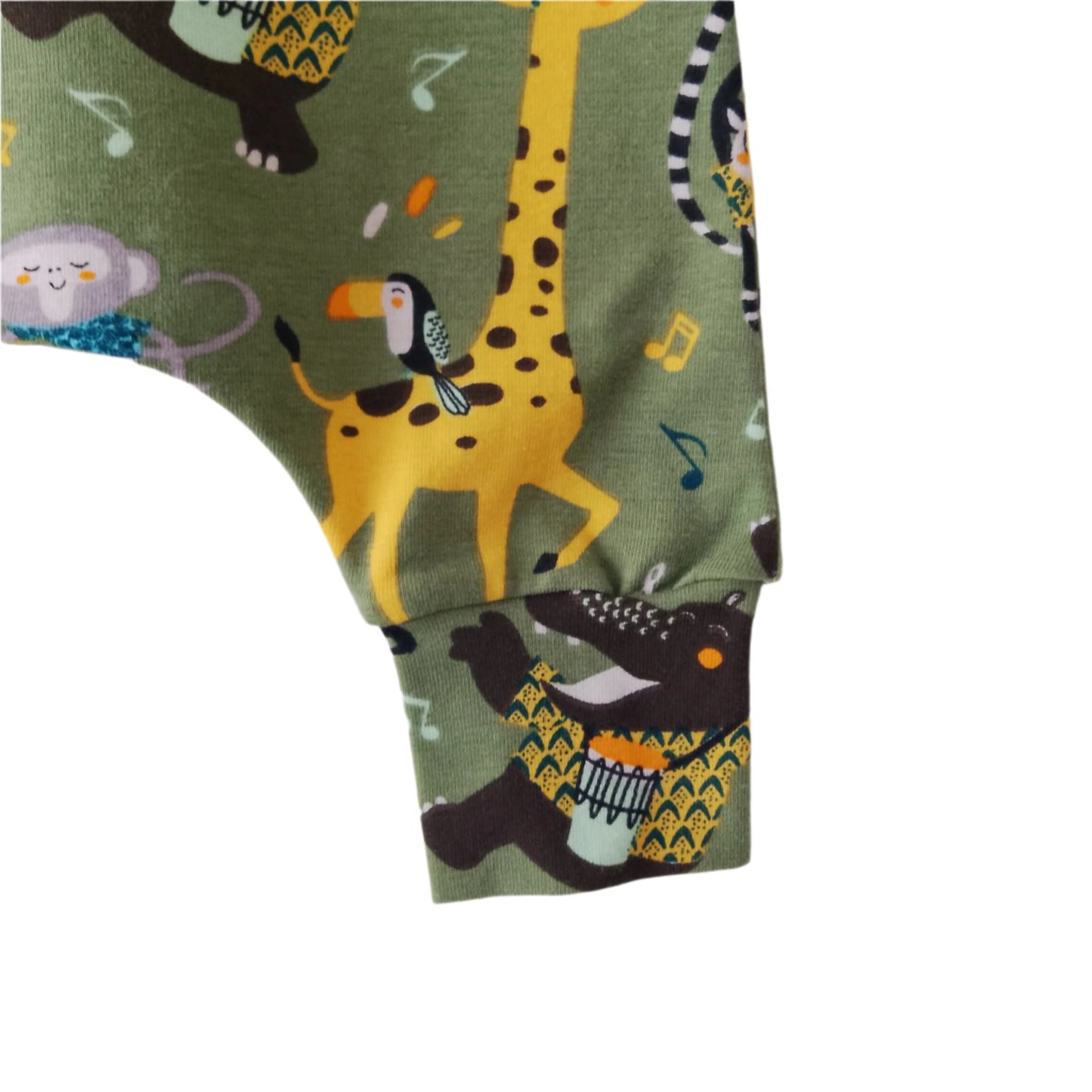 detail of green jersey baby romper, featuring cartoon safari animals