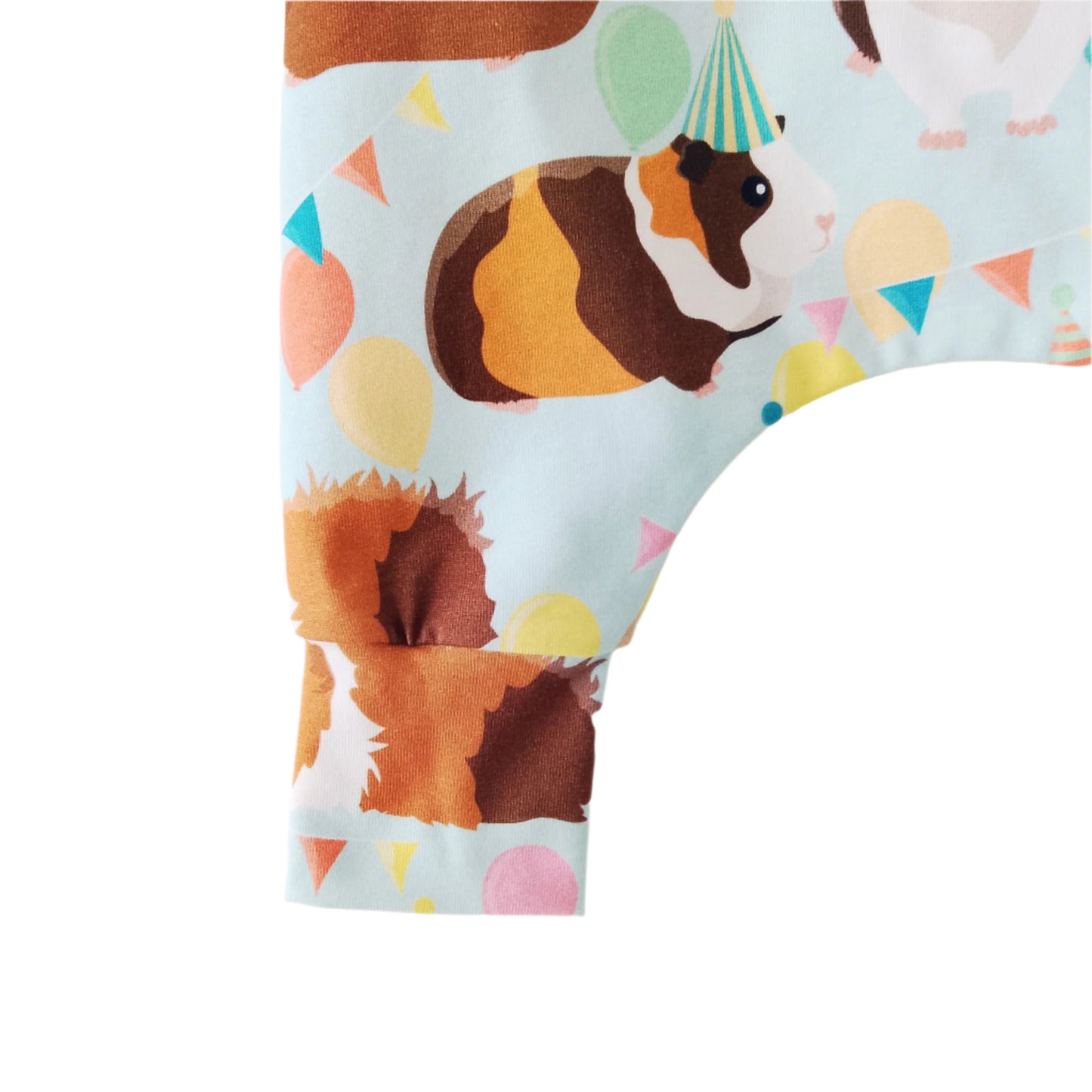close up detail of pastel baby romper ankle cuff, featuring cute guinea pigs
