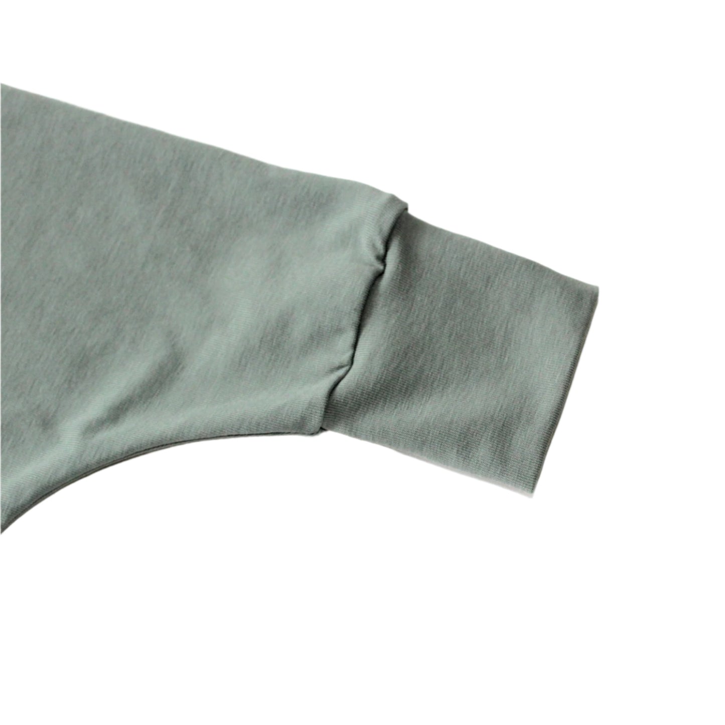 dusty mint plain jersey baby harem romper ankle detail, against a white background