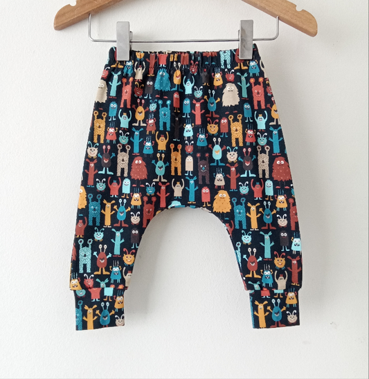 Navy baby leggings with multicoloured cartoon monsters