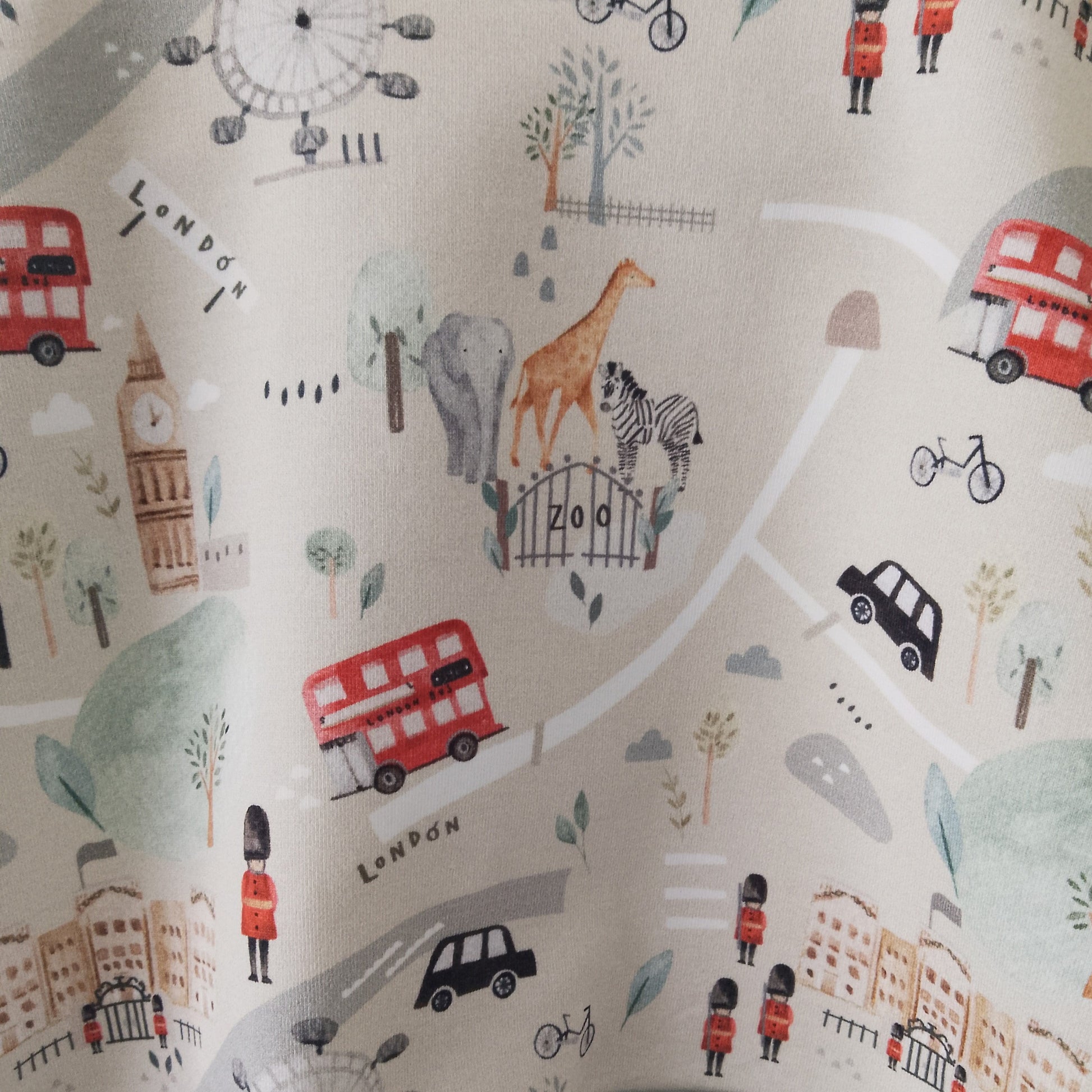 detail of beige baby sweatshirt with illustrations of london tourist attractions